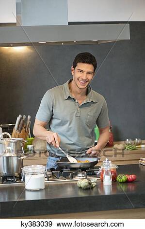 Man preparing food in the kitchen View Large Photo Image Stock Photo - Man preparing food in the kitchen. Fotosearch