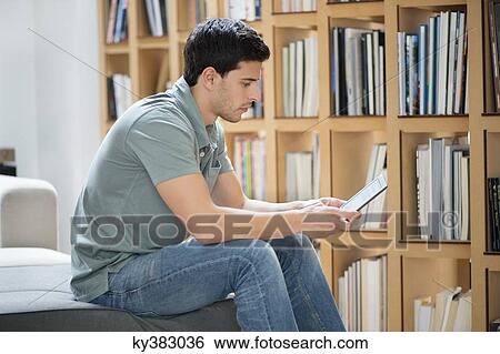 Man reading an electronic book View Large Photo Image Stock Photograph - Man reading an electronic book. Fotosearch