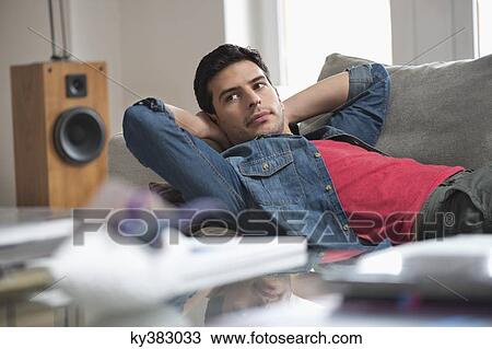 Man resting on a couch View Large Photo Image Stock Image - Man resting on a couch. Fotosearch