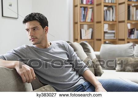 Stock Photo - Man resting on a couch. Fotosearch