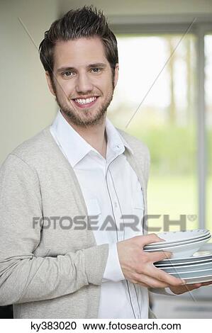Portrait of a man carrying plates View Large Photo Image Stock Image - Portrait of a man carrying plates. Fotosearch