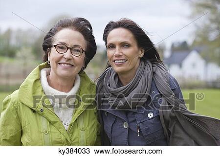Two women in a park View Large Photo Image Stock Image - Two women in a park. Fotosearch