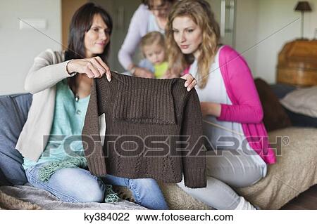 Woman and her daughter looking a sweater View Large Photo Image Stock Image - Woman and her daughter looking a sweater. Fotosearch