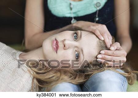 Stock Image - Woman lying on her mother's lap. Fotosearch