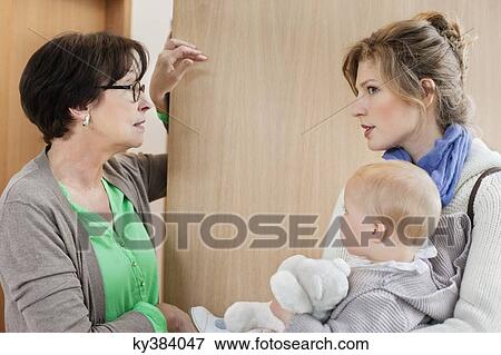 Woman talking to nanny at the doorway View Large Photo Image Stock Photo - Woman talking to nanny at the doorway. Fotosearch