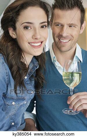 Picture - Couple drinking wine in the kitchen. Fotosearch