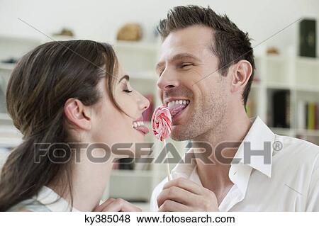 Couple sharing a candy View Large Photo Image Stock Photo - Couple sharing a candy. Fotosearch