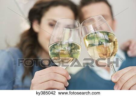 Couple toasting with wine View Large Photo Image Stock Image - Couple toasting with wine. Fotosearch