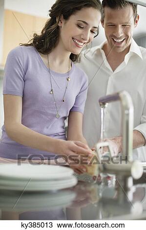 Woman washing utensils in the kitchen View Large Photo Image Stock Image - Woman washing utensils in the kitchen. Fotosearch