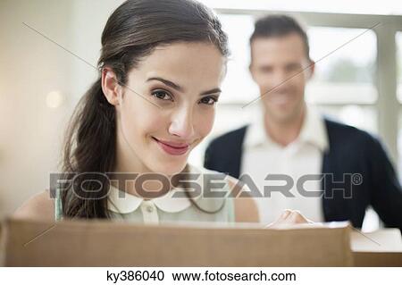 Couple carrying cardboard boxes at their new home View Large Photo Image Stock Image - Couple carrying cardboard boxes at their new home. Fotosearch