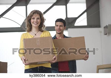 Picture - Couple carrying cardboard boxes. Fotosearch