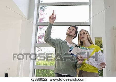Couple choosing color for their house from a color chart View Large Photo Image Stock Image - Couple choosing color for their house from a color chart. Fotosearch