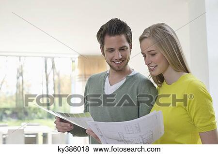 Couple choosing color for their house from a color chart View Large Photo Image Stock Photo - Couple choosing color for their house from a color chart. Fotosearch