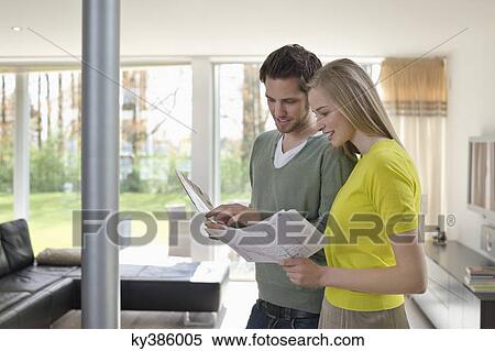 Couple choosing color for their house from a color chart View Large Photo Image Stock Photography - Couple choosing color for their house from a color chart. Fotosearch