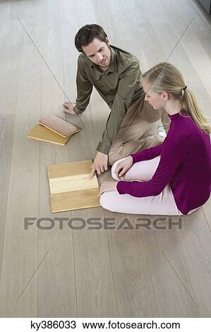 High angle view of a couple choosing laminated boards View Large Photo Image Stock Image - High angle view of a couple choosing laminated boards. Fotosearch