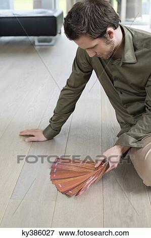 High angle view of a man holding laminated boards View Large Photo Image Stock Photo - High angle view of a man holding laminated boards. Fotosearch