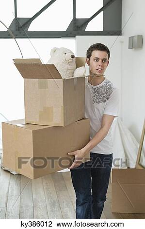 Man carrying cardboard boxes View Large Photo Image Stock Image - Man carrying cardboard boxes. Fotosearch