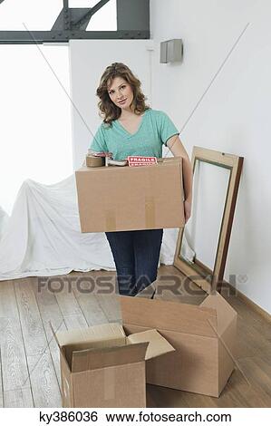 Woman carrying cardboard boxes View Large Photo Image Stock Photograph - Woman carrying cardboard boxes. Fotosearch