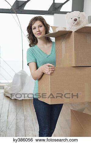 Woman carrying cardboard boxes View Large Photo Image Stock Photograph - Woman carrying cardboard boxes. Fotosearch