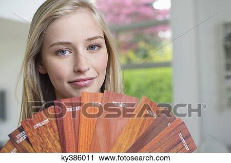 Woman holding laminated boards View Large Photo Image Stock Image - Woman holding laminated boards. Fotosearch