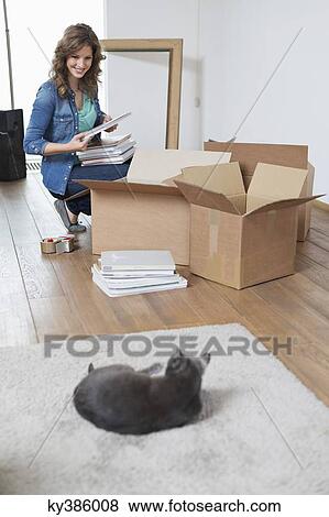 Woman looking at her cat and smiling View Large Photo Image Stock Photo - Woman looking at her cat and smiling. Fotosearch
