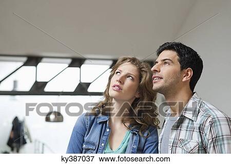 Close-up of a couple looking up View Large Photo Image Stock Photo - Close-up of a couple looking up. Fotosearch