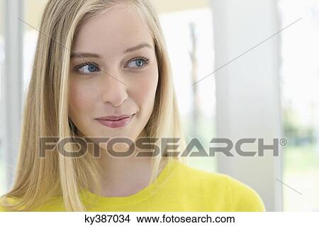 Picture - Close-up of a woman smirking. Fotosearch