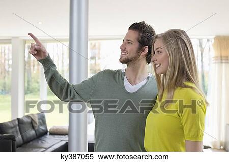 Stock Photography - Man showing house interiors to a woman. Fotosearch