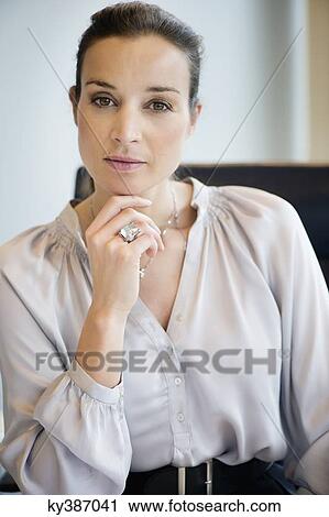 Stock Image - Portrait of a businesswoman in an office. Fotosearch