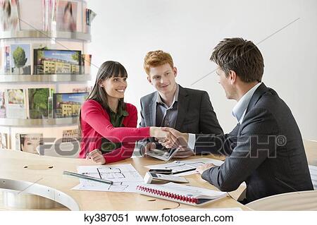 Real estate agent discussing property documents to his clients View Large Photo Image Stock Image - Real estate agent discussing property documents to his clients. Fotosearch