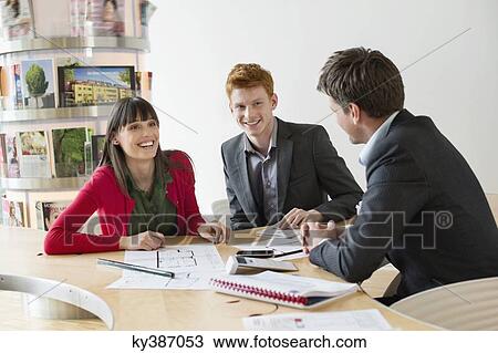 Real estate agent discussing property documents to his clients View Large Photo Image Stock Image - Real estate agent discussing property documents to his clients. Fotosearch