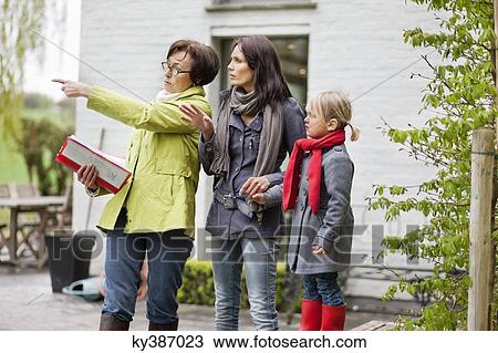 Real estate agent showing woman a house View Large Photo Image Stock Image - Real estate agent showing woman a house. Fotosearch