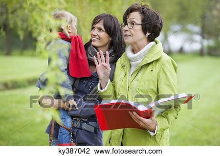 Stock Image - Real estate agent showing woman a property. Fotosearch