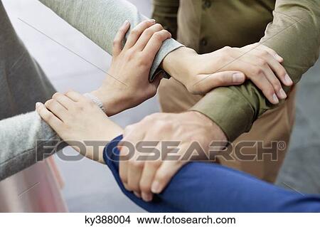 Close-up of connecting hands of business executives View Large Photo Image Picture - Close-up of connecting hands of business executives. Fotosearch