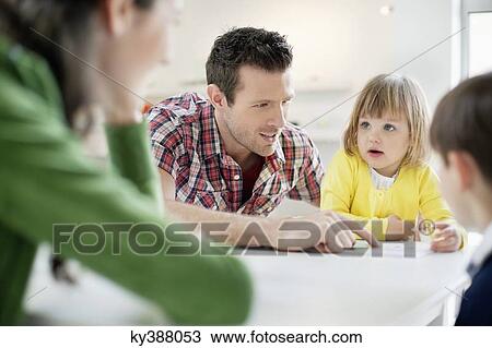 Couple teaching their children at home View Large Photo Image Stock Image - Couple teaching their children at home. Fotosearch