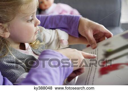 Stock Photo - Girl studying with her father at home. Fotosearch