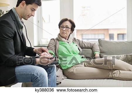 Male doctor examining a patient View Large Photo Image Stock Photograph - Male doctor examining a patient. Fotosearch