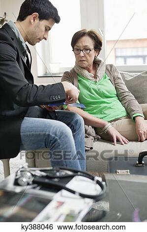 Male doctor examining a patient View Large Photo Image Stock Photograph - Male doctor examining a patient. Fotosearch