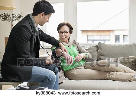 Male doctor examining a patient with stethoscope View Large Photo Image Stock Image - Male doctor examining a patient with stethoscope. Fotosearch
