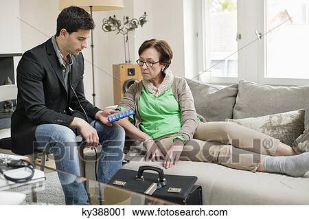 Male doctor explaining about medicines to a patient View Large Photo Image Stock Image - Male doctor explaining about medicines to a patient. Fotosearch