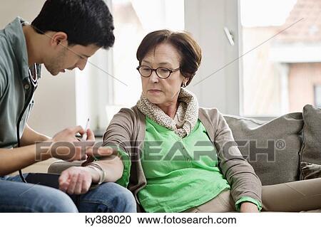 Male doctor giving an injection to a patient View Large Photo Image Stock Image - Male doctor giving an injection to a patient. Fotosearch