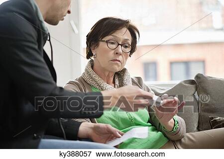 Male doctor giving medicine to a patient View Large Photo Image Stock Photo - Male doctor giving medicine to a patient. Fotosearch