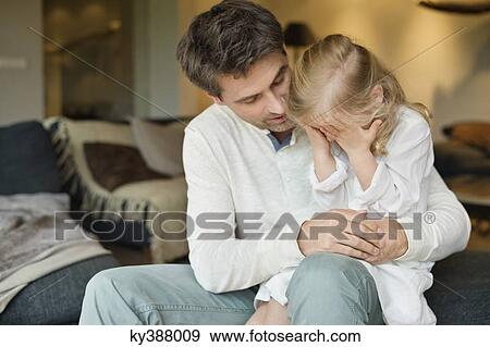 Man holding his cute daughter covering her eyes with hands View Large Photo Image Stock Photo - Man holding his cute daughter covering her eyes with hands. Fotosearch