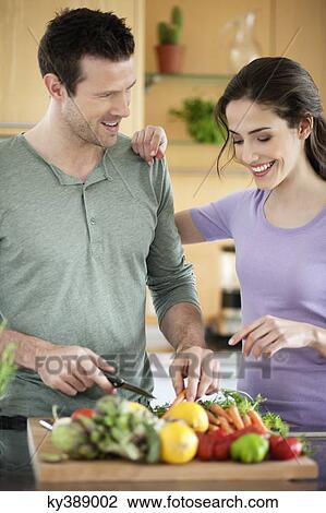 Couple cooking in the kitchen View Large Photo Image Stock Image - Couple cooking in the kitchen. Fotosearch