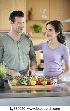Couple cooking in the kitchen View Large Photo Image Stock Image - Couple cooking in the kitchen. Fotosearch