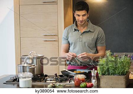 Man preparing food in the kitchen View Large Photo Image Picture - Man preparing food in the kitchen. Fotosearch