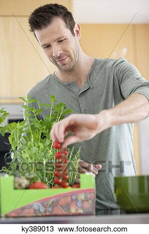 Man preparing food in the kitchen View Large Photo Image Stock Image - Man preparing food in the kitchen. Fotosearch