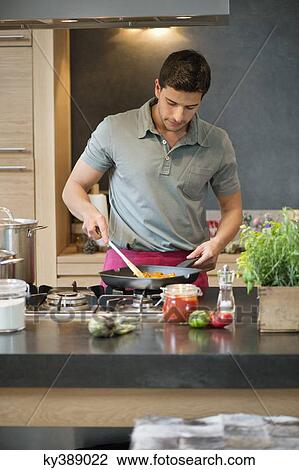Man preparing food in the kitchen View Large Photo Image Stock Image - Man preparing food in the kitchen. Fotosearch