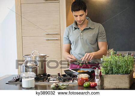 Man preparing food in the kitchen View Large Photo Image Stock Image - Man preparing food in the kitchen. Fotosearch