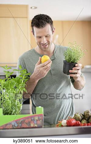 Man preparing food in the kitchen View Large Photo Image Stock Image - Man preparing food in the kitchen. Fotosearch